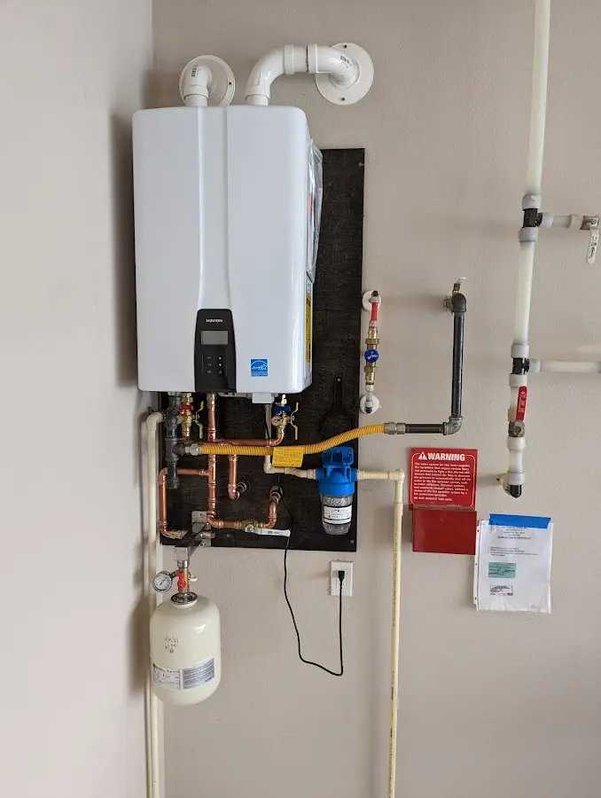 Professional plumber installing copper piping in a Provo home
